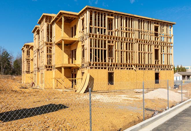 a close-up of temporary chain link fences enclosing a construction site, signaling progress in the project's development in Melrose